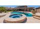 Inviting backyard pool and spa with beautiful stone surround, perfect for relaxation and entertainment at 30277 N 125Th Ln, Peoria, AZ 85383