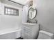 Bright bathroom featuring a shower-tub combo, vanity with storage, and modern lighting fixtures at 3031 E Avalon Dr, Phoenix, AZ 85016