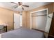 Spacious bedroom with ceiling fan, closet, and views of ensuite, perfect for relaxation and convenience at 3031 E Avalon Dr, Phoenix, AZ 85016
