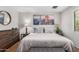 Serene bedroom with a plush bed, wood furniture, and soft lighting for a peaceful ambiance at 3031 E Avalon Dr, Phoenix, AZ 85016