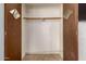 Empty closet with dark wooden accents and ample storage space, ready for customization and organization at 3031 E Avalon Dr, Phoenix, AZ 85016