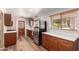 Well-equipped kitchen with stainless steel appliances, stylish cabinets, and wooden flooring at 3031 E Avalon Dr, Phoenix, AZ 85016