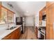 Bright, modern kitchen with stainless steel appliances, wooden cabinetry, and durable vinyl flooring at 3031 E Avalon Dr, Phoenix, AZ 85016