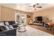 Comfortable living room featuring a ceiling fan, a gray sofa, and glass paneled french doors at 3031 E Avalon Dr, Phoenix, AZ 85016