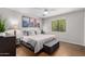Calm main bedroom with neutral tones, complemented by three landscape paintings, and a padded bench at 3031 E Avalon Dr, Phoenix, AZ 85016