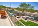 A well-appointed outdoor space including a built-in grill, dining area, and green lawn with a putting green at 31256 N 40Th Pl, Cave Creek, AZ 85331