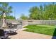 This backyard has a covered patio, outdoor kitchen, stone wall, putting green and artificial grass at 31256 N 40Th Pl, Cave Creek, AZ 85331