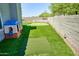 Expansive backyard complete with lush artificial turf, putting green, and outdoor kitchen, perfect for recreation at 31256 N 40Th Pl, Cave Creek, AZ 85331