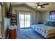 Cozy bedroom featuring a ceiling fan, balcony access, and stylish decor at 31256 N 40Th Pl, Cave Creek, AZ 85331