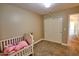 A Bedroom with a crib, plush carpet, and ample closet space, creating a comforting and organized environment at 31256 N 40Th Pl, Cave Creek, AZ 85331