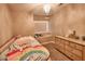 Cozy bedroom features a rainbow themed bed set, dresser, chandelier and window seat for relaxation at 31256 N 40Th Pl, Cave Creek, AZ 85331