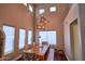 Bright dining room featuring a wooden table, modern light fixture and tall ceilings with clerestory windows at 31256 N 40Th Pl, Cave Creek, AZ 85331