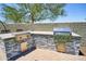 Outdoor kitchen with two grills and stone accents, ideal for outdoor cooking and entertaining at 31256 N 40Th Pl, Cave Creek, AZ 85331