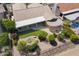 Aerial view of the property's backyard featuring a patio, covered seating area, pond, and desert landscaping at 3394 N 147Th Ln, Goodyear, AZ 85395