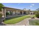 A large backyard with covered patio, outdoor seating, lush lawn and landscaping at 3394 N 147Th Ln, Goodyear, AZ 85395