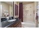 Bathroom features a vanity with granite countertop, a shower-tub combination, and contemporary decor at 3394 N 147Th Ln, Goodyear, AZ 85395