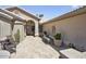 Inviting front courtyard with tiled flooring, comfortable seating, and potted plants, offering a relaxing outdoor space at 3394 N 147Th Ln, Goodyear, AZ 85395