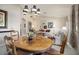 Comfortable dining room featuring an elegant chandelier and a light filled living space at 3394 N 147Th Ln, Goodyear, AZ 85395