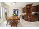 Bright dining room with a round wooden table, neutral walls, and a view of the exterior at 3394 N 147Th Ln, Goodyear, AZ 85395