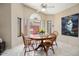 Sunny dining area with a round wooden table, comfortable seating, and natural light at 3394 N 147Th Ln, Goodyear, AZ 85395