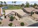 Aerial view of a single-story home featuring well-maintained landscaping, a large garage, and a view of the golf course at 3394 N 147Th Ln, Goodyear, AZ 85395