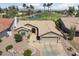 Aerial view of a single-story home featuring well-maintained landscaping, a large garage, and a view of the golf course at 3394 N 147Th Ln, Goodyear, AZ 85395