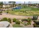 Aerial view of pond and golf course, highlighting landscaping with backyard pond feature at 3394 N 147Th Ln, Goodyear, AZ 85395