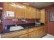 Kitchenette features custom wood cabinets, granite countertops, and a sink area at 3394 N 147Th Ln, Goodyear, AZ 85395