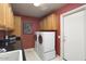 Laundry room featuring a sink area, updated machines, and storage cabinets at 3394 N 147Th Ln, Goodyear, AZ 85395