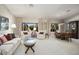 Spacious living room with plush seating, large windows, and a dining area, perfect for gatherings and relaxation at 3394 N 147Th Ln, Goodyear, AZ 85395