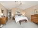Serene bedroom with a ceiling fan, neutral walls, carpet floors, and wooden furniture at 3394 N 147Th Ln, Goodyear, AZ 85395