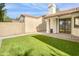 Private backyard featuring lush artificial grass, pavers, and a covered patio for outdoor relaxation at 3440 E Southern Ave # 1107, Mesa, AZ 85204