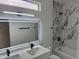 Modern bathroom featuring dual sinks, illuminated mirror, and stylish tiled walls and bathtub at 3440 E Southern Ave # 1107, Mesa, AZ 85204