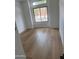 Bedroom featuring wood floors, and a large window with a view of the outdoors at 3440 E Southern Ave # 1107, Mesa, AZ 85204