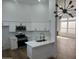 Modern kitchen featuring white cabinets, stainless steel appliances, quartz countertops, and a stylish island at 3440 E Southern Ave # 1107, Mesa, AZ 85204