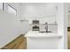 Modern kitchen with white cabinets, stainless steel appliances, and a breakfast bar at 3440 E Southern Ave # 1107, Mesa, AZ 85204