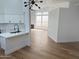 Open-concept living area featuring modern lighting, wood flooring, a fireplace, and large windows at 3440 E Southern Ave # 1107, Mesa, AZ 85204