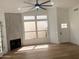 Spacious living room featuring a fireplace, lots of windows, and a ceiling fan at 3440 E Southern Ave # 1107, Mesa, AZ 85204