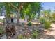 Backyard showcasing a detached garage, mature trees, and vegetation at 3526 E Cheery Lynn Rd, Phoenix, AZ 85018