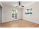 Bedroom featuring laminate floors, white walls, and a window with a view at 3526 E Cheery Lynn Rd, Phoenix, AZ 85018