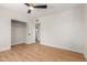 Bedroom featuring laminate floors, white walls, ceiling fan, and closet at 3526 E Cheery Lynn Rd, Phoenix, AZ 85018