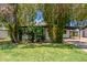 The house is surrounded by mature trees and a well-maintained green lawn at 3526 E Cheery Lynn Rd, Phoenix, AZ 85018