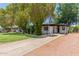 The home boasts a long driveway and is surrounded by mature trees and greenery at 3526 E Cheery Lynn Rd, Phoenix, AZ 85018