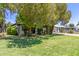 Charming single-story home surrounded by mature trees and a lush green lawn at 3526 E Cheery Lynn Rd, Phoenix, AZ 85018