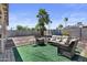 A cozy backyard featuring a green lawn, seating, and desert landscaping for relaxing outdoors at 3636 W Crocus Dr, Phoenix, AZ 85053