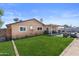 Inviting backyard featuring a lush lawn and a covered patio with comfortable seating and outdoor dining area at 3636 W Crocus Dr, Phoenix, AZ 85053