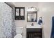 Bathroom featuring decorative mirror and vanity with dark wood finish at 3636 W Crocus Dr, Phoenix, AZ 85053