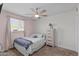 Bright bedroom with soft pink walls, ceiling fan, and natural light at 3636 W Crocus Dr, Phoenix, AZ 85053