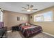 Comfortable bedroom with ceiling fan, closet, and windows that offer natural light and a cozy ambiance at 3636 W Crocus Dr, Phoenix, AZ 85053