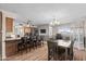 Open concept dining area showcases stylish light fixture and wood-look floors at 3636 W Crocus Dr, Phoenix, AZ 85053